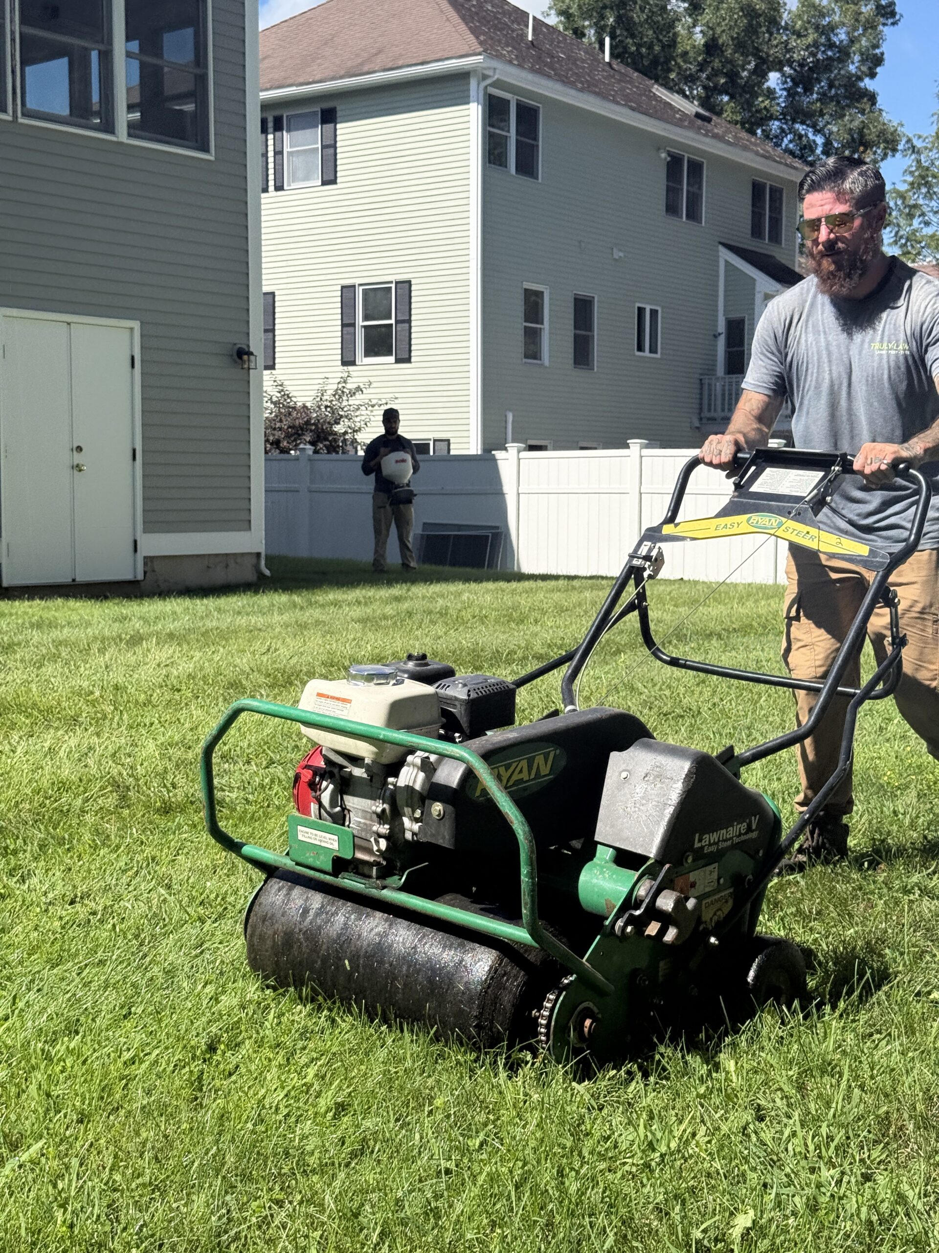 Truly Lawn core aerator performing a lawn treatment