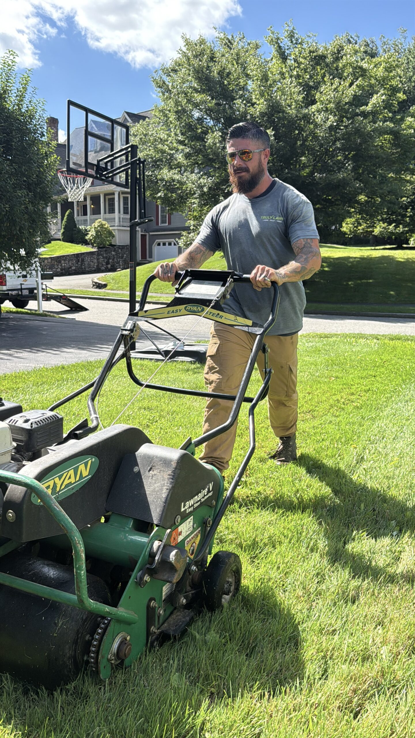 Truly Lawn aeration technician servicing a Massachusetts lawn